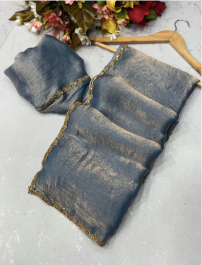 Blue denim pouches with gold trim on a light gray surface with flowers in the background