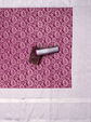 Lipstick on a pink and white patterned fabric