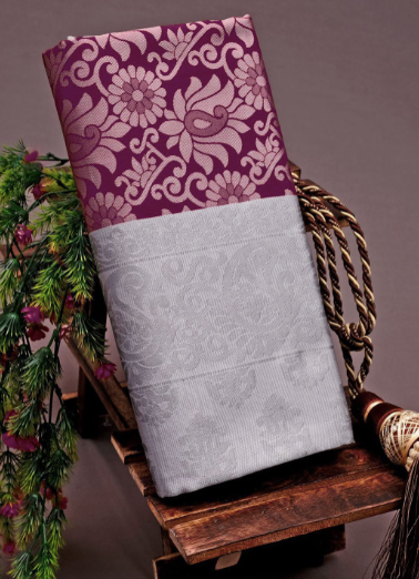 Two fabric swatches, one purple with floral patterns and one gray, on a wooden stand against a brown background.