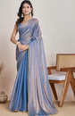 Woman wearing a blue saree with a plain background