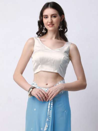 Woman wearing a white top and blue skirt on a white background