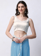 Woman wearing a white top and blue skirt on a white background
