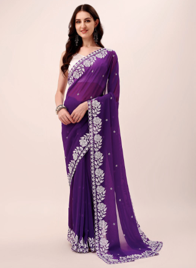 Woman wearing a purple saree with white embroidery on a beige background