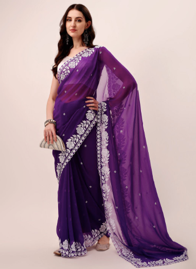 Woman wearing a purple saree with white embroidery on a beige background