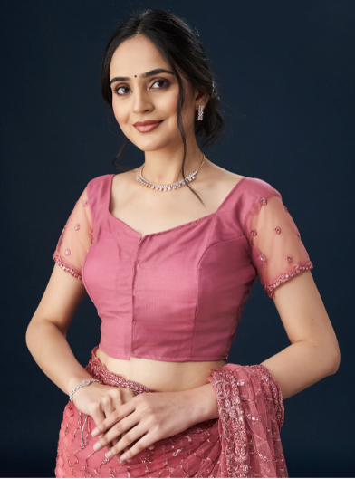 Woman wearing a pink traditional outfit with a dark background