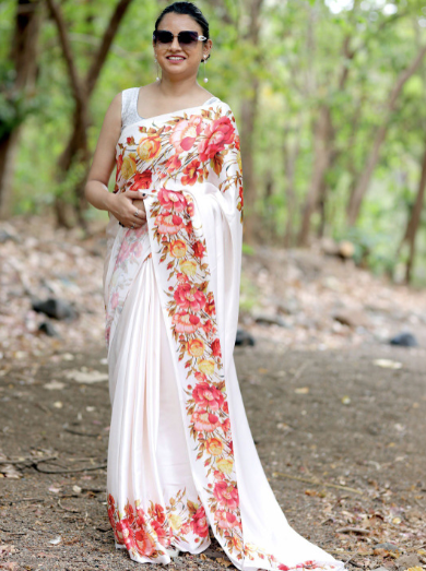 Woman wearing a floral saree in a forest setting