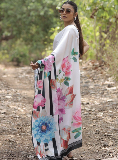 Woman wearing a floral kimono in a natural setting