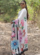 Woman wearing a floral kimono in a natural setting