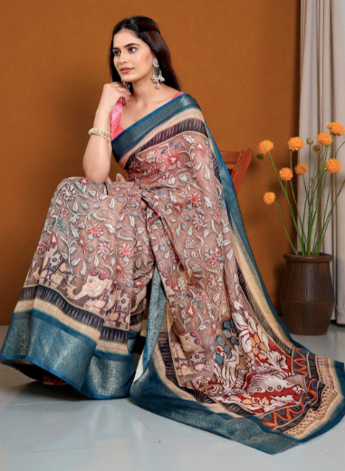 Woman wearing a traditional saree with a floral pattern against an orange wall.