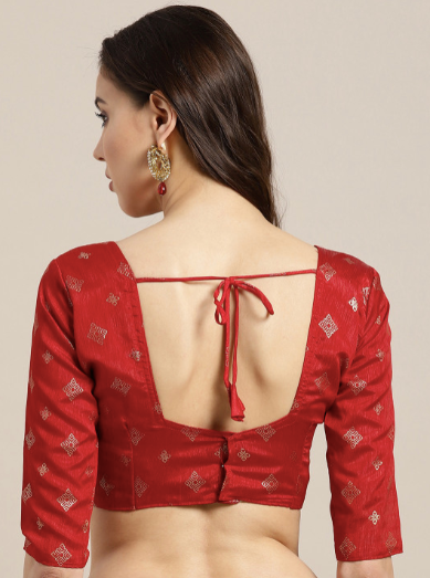 Red blouse with open back design on a neutral background