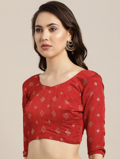 Woman wearing a red blouse with intricate patterns on a beige background