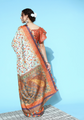 Woman wearing a colorful saree with a blue background