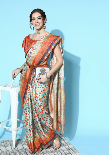 Woman wearing a colorful saree against a light blue background