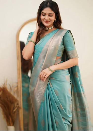 Woman wearing a turquoise saree with a white background
