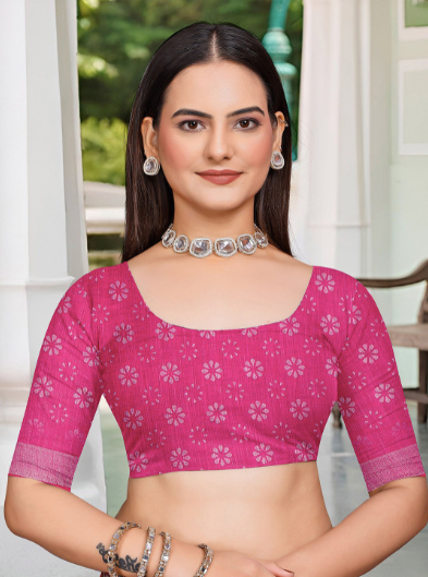 Woman wearing a pink blouse with white patterns in an outdoor setting