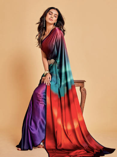 Woman wearing a colorful saree with a gradient design on a beige background