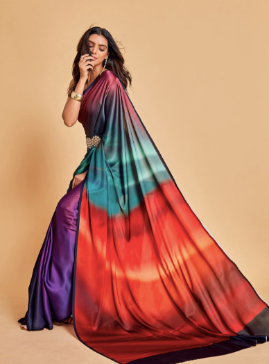Woman wearing a colorful saree with a gradient design on a beige background