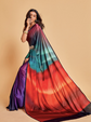 Woman wearing a colorful saree with a gradient design on a beige background