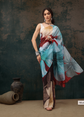 Woman wearing a colorful dress with abstract patterns against a dark background