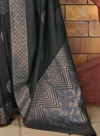 Black fabric with geometric patterns draped over a wooden surface
