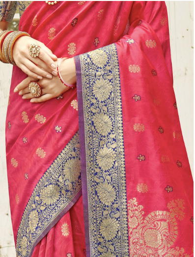 Red saree with gold and blue patterns, held by a hand.