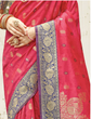 Red saree with gold and blue patterns, held by a hand.