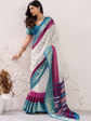 Woman wearing a colorful saree with a white textured wall background