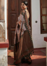Woman in a saree standing in a room with wooden doors and a window.